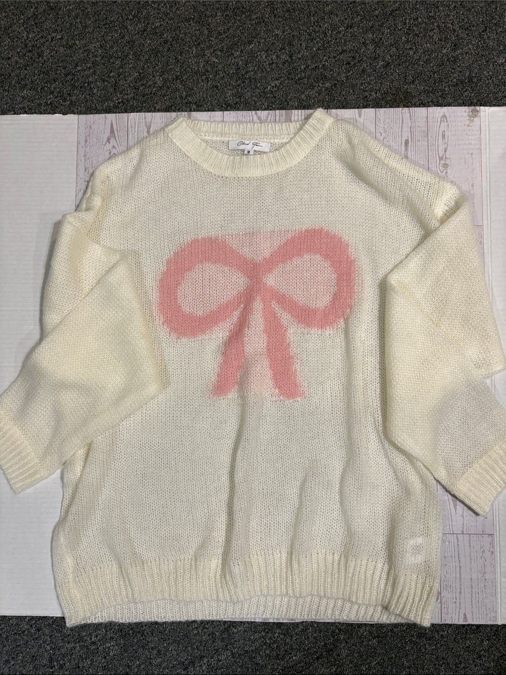 Cloud Ten Cream Crewneck Sweater with Pink Bow Motif. Boutique